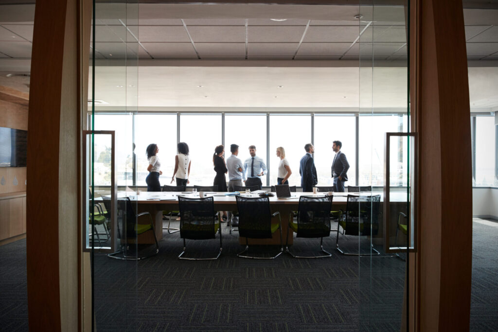 Businesspeople standing about a table